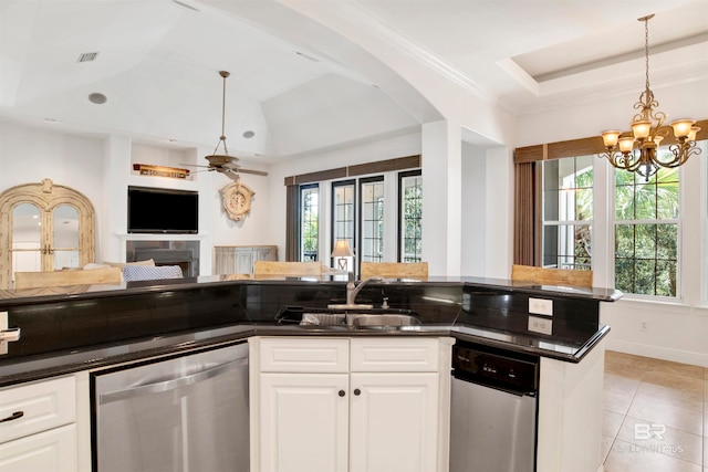 kitchen featuring a healthy amount of sunlight, dishwasher, and white cabinets