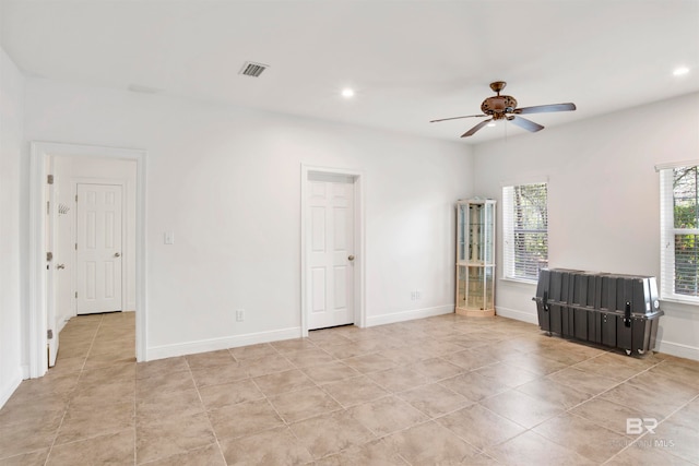 tiled empty room with ceiling fan