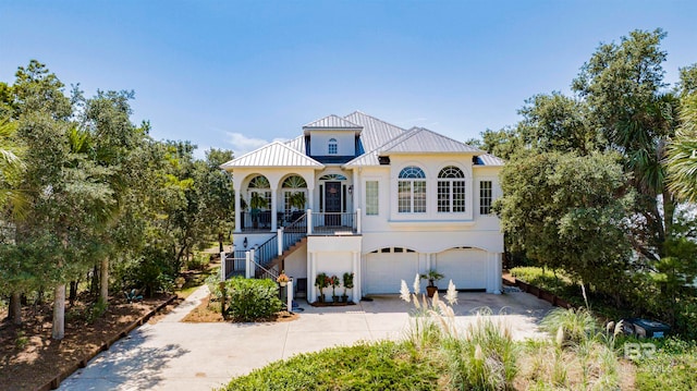 mediterranean / spanish home with covered porch and a garage