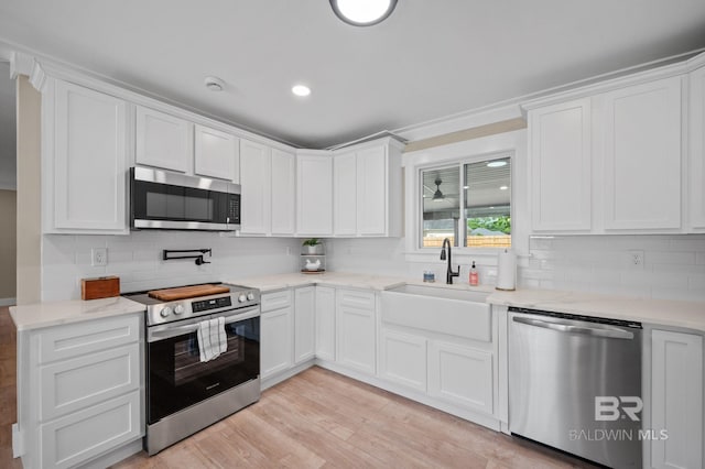 751 Abbey Way, Mobile, AL 36695 - kitchen featuring appliances with stainless steel finishes, a sink, tasteful backsplash, white cabinets, and recessed lighting