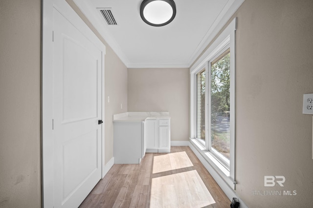 751 Abbey Way, Mobile, AL 36695 - washroom with light wood-style floors, crown molding, and baseboards