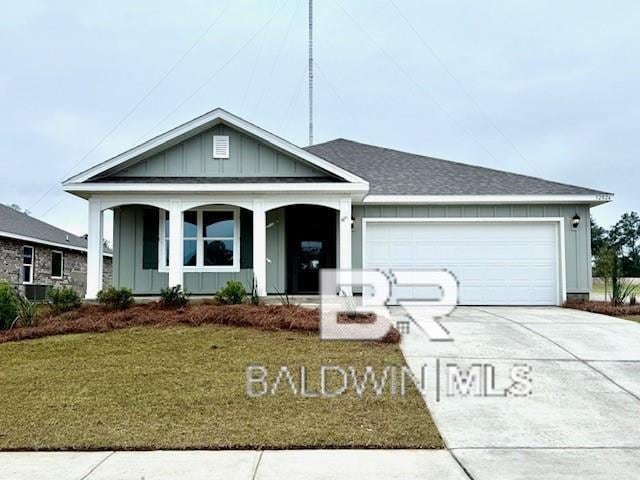 32062 Lyon Rd, Spanish Fort, AL 36527 - single story home featuring board and batten siding, covered porch, concrete driveway, an attached garage, and a front yard