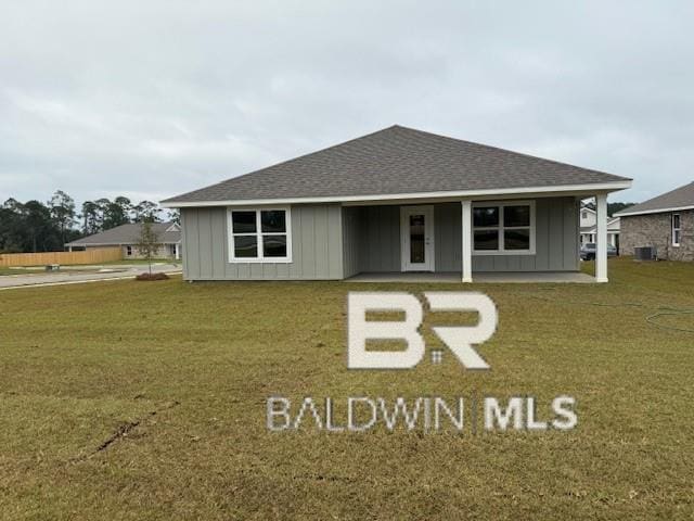 32062 Lyon Rd, Spanish Fort, AL 36527 - view of front facade featuring board and batten siding, a front yard, and a shingled roof