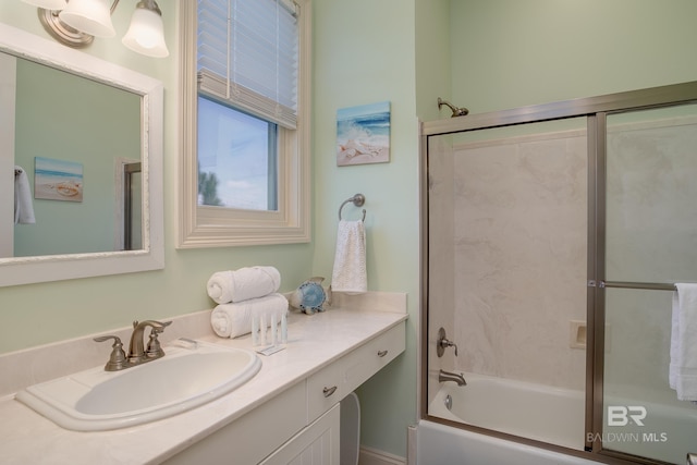 full bathroom with combined bath / shower with glass door and vanity