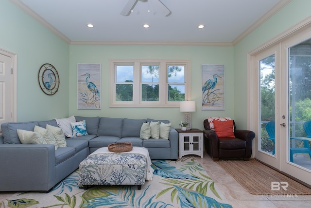living area featuring a wealth of natural light, crown molding, and tile patterned flooring
