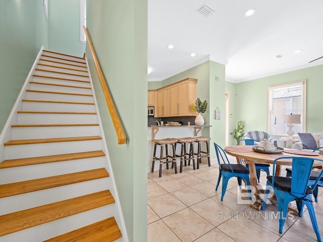 interior space featuring tile patterned flooring, visible vents, recessed lighting, and ornamental molding