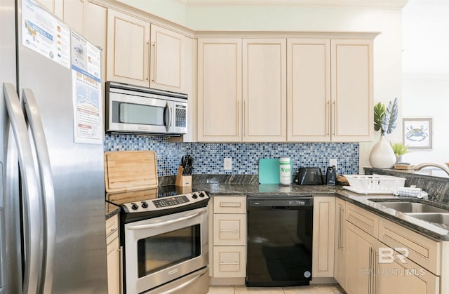 kitchen featuring cream cabinets and appliances with stainless steel finishes