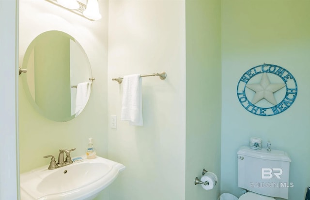 half bath with toilet and a sink