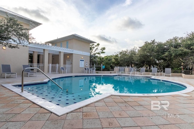 pool featuring a patio, fence, and a pergola