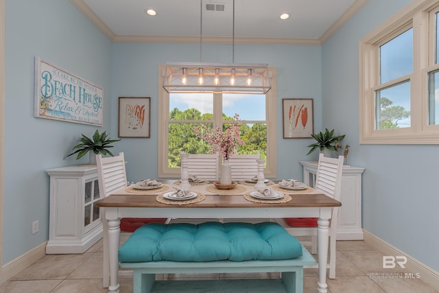 dining space featuring light tile patterned flooring, visible vents, crown molding, and baseboards