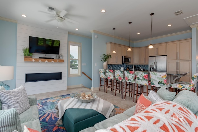 living room featuring light tile patterned floors, visible vents, ceiling fan, and crown molding