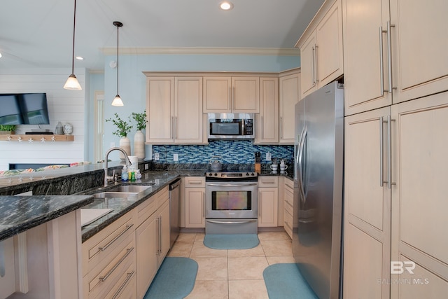 kitchen with decorative backsplash, a peninsula, light tile patterned flooring, stainless steel appliances, and a sink