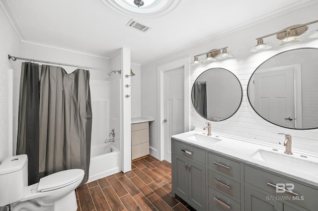 24663 Chestnut St Unit A & B, Elberta, AL 36530 - bathroom featuring ornamental molding, wood finished floors, toilet, double vanity, and shower / bath combo with shower curtain