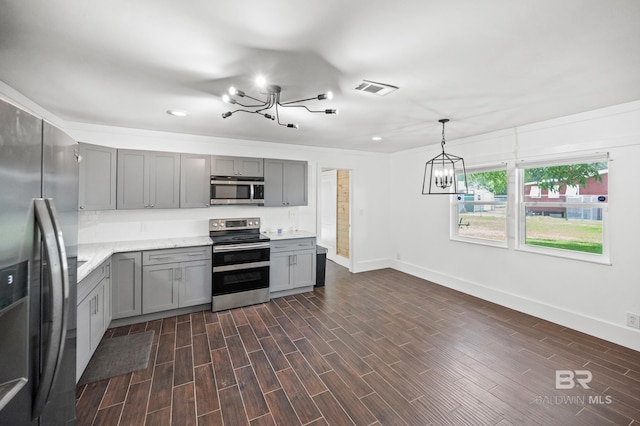 24663 Chestnut St Unit A & B, Elberta, AL 36530 - kitchen with appliances with stainless steel finishes, a chandelier, gray cabinetry, baseboards, and dark wood-type flooring