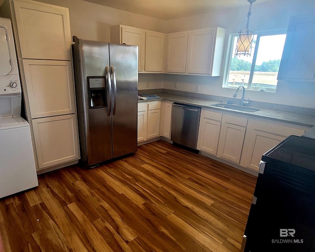 24663 Chestnut St Unit A & B, Elberta, AL 36530 - kitchen with appliances with stainless steel finishes, a sink, stacked washer / drying machine, dark wood finished floors, and white cabinetry