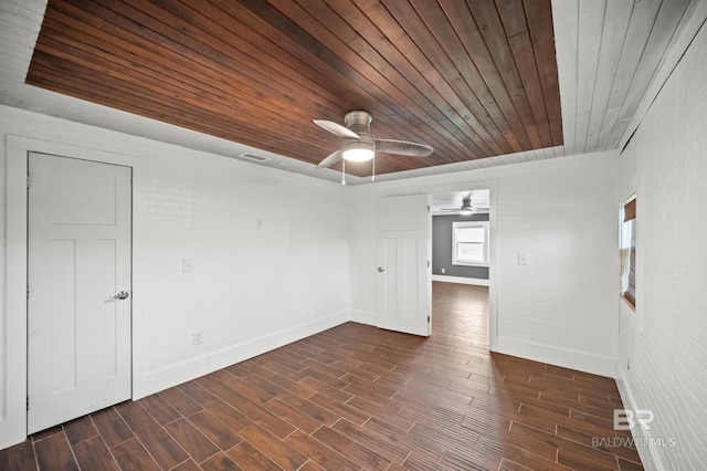 24663 Chestnut St Unit A & B, Elberta, AL 36530 - spare room featuring wooden ceiling, baseboards, a ceiling fan, dark wood-style floors, and brick wall