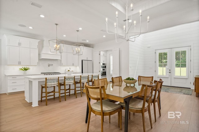 dining area featuring visible vents, light wood-style flooring, an inviting chandelier, french doors, and recessed lighting