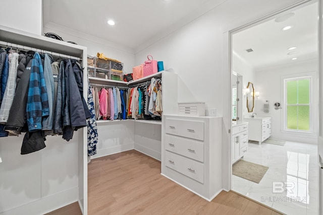 spacious closet featuring light wood-style flooring and visible vents