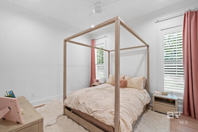 bedroom with ornamental molding and baseboards