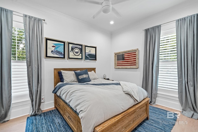 bedroom with baseboards, crown molding, recessed lighting, and light wood-style floors