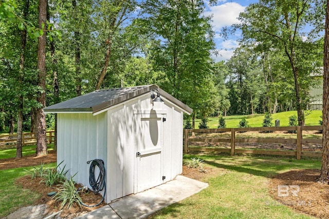 view of shed with fence