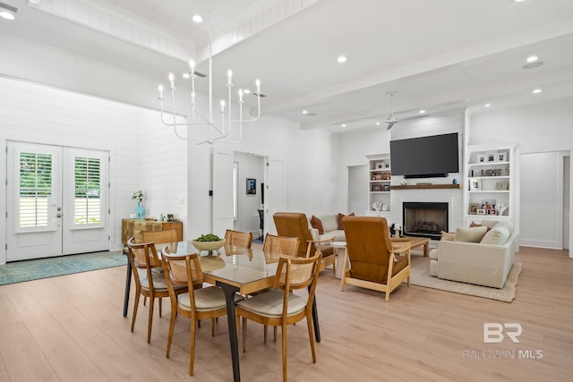 dining area featuring light wood finished floors, a large fireplace, beamed ceiling, french doors, and recessed lighting