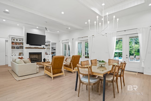 dining room with french doors, light wood-type flooring, beam ceiling, and a healthy amount of sunlight