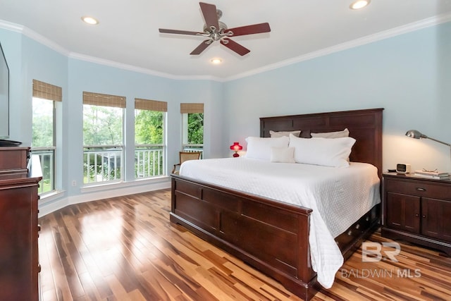 bedroom featuring ornamental molding, light wood-type flooring, and ceiling fan