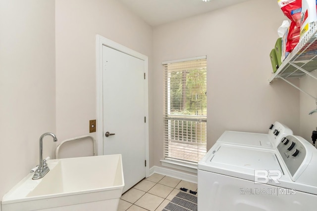 laundry room with separate washer and dryer, plenty of natural light, light tile patterned floors, and sink