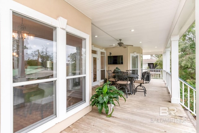 wooden terrace featuring ceiling fan