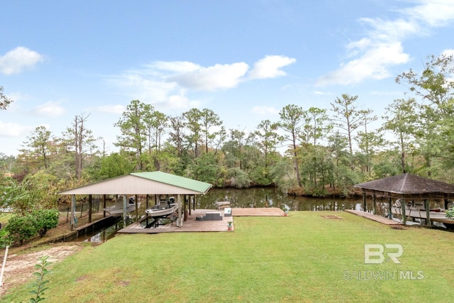 view of yard with a water view and a boat dock