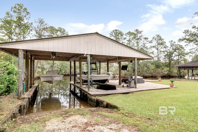 dock area with a water view, a yard, and a gazebo