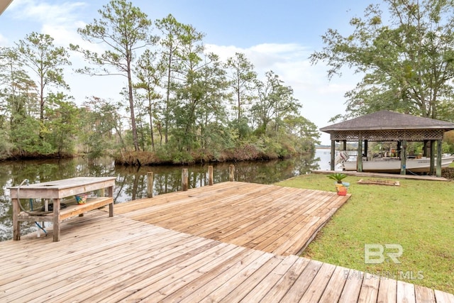 dock area with a water view and a yard