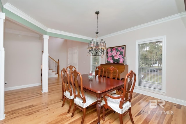 dining space with an inviting chandelier, light hardwood / wood-style flooring, and ornamental molding