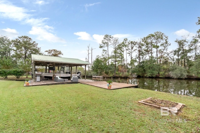 view of yard featuring a dock and a deck with water view