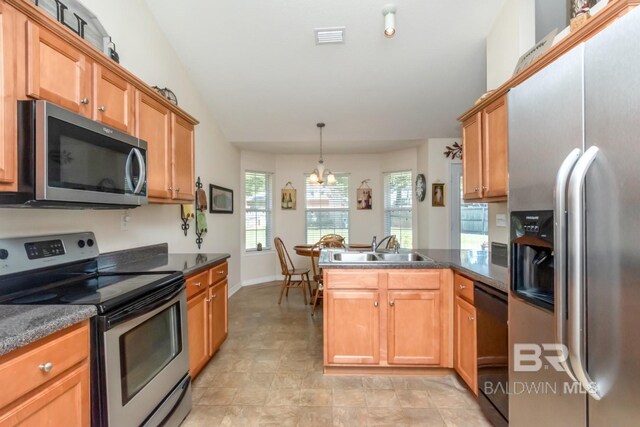 kitchen with a chandelier, appliances with stainless steel finishes, light tile patterned floors, sink, and kitchen peninsula