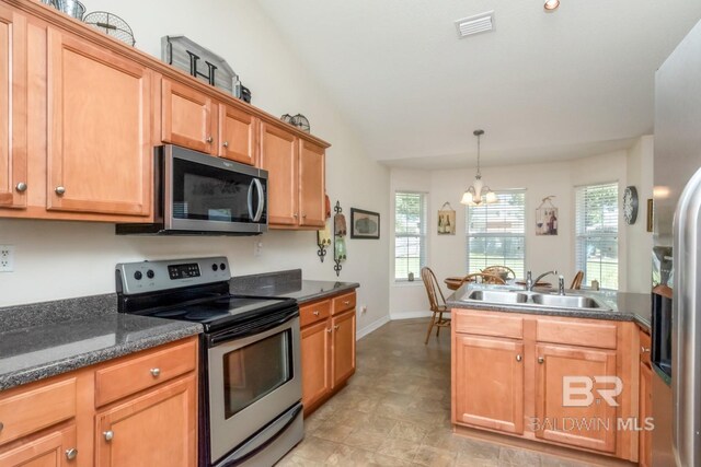 kitchen featuring light tile patterned flooring, sink, appliances with stainless steel finishes, a chandelier, and vaulted ceiling