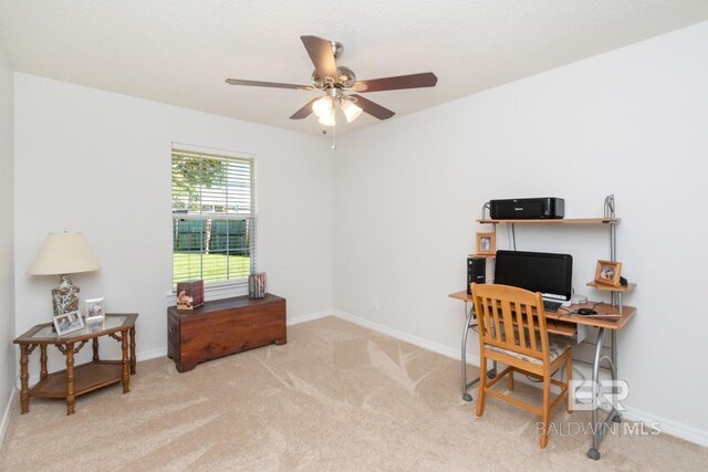 office space featuring ceiling fan and light carpet