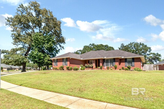 ranch-style home featuring a front yard