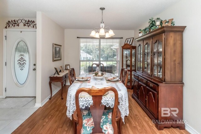 dining space with a notable chandelier and wood-type flooring