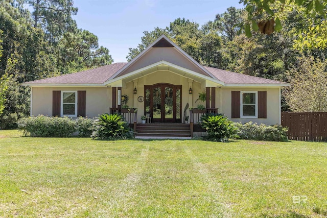 ranch-style house featuring a front yard, french doors, and a porch