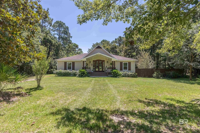 ranch-style home featuring french doors and a front yard