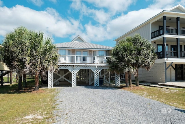 raised beach house featuring a carport