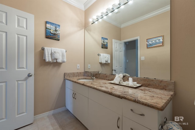 bathroom featuring tile patterned floors, baseboards, vanity, and crown molding