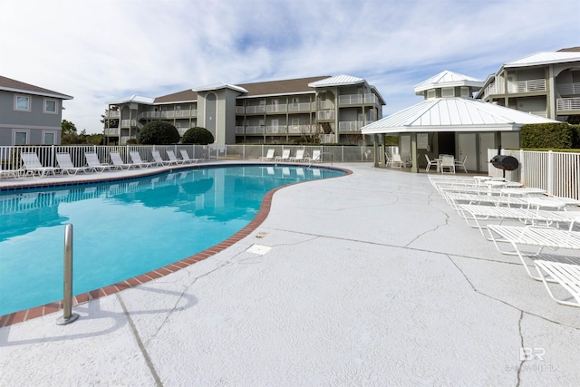 community pool featuring a gazebo, a patio, and fence