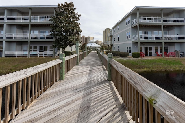 view of home's community featuring a lawn and a water view