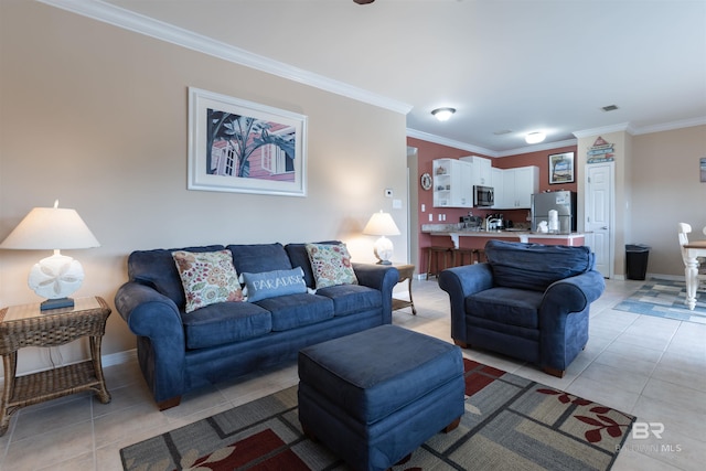 living area featuring visible vents, baseboards, light tile patterned flooring, and crown molding