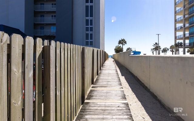 view of home's community featuring fence