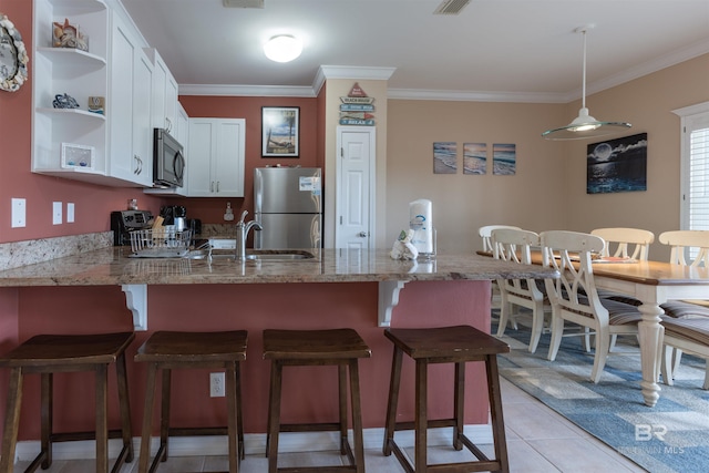 kitchen with open shelves, freestanding refrigerator, a peninsula, white cabinets, and crown molding