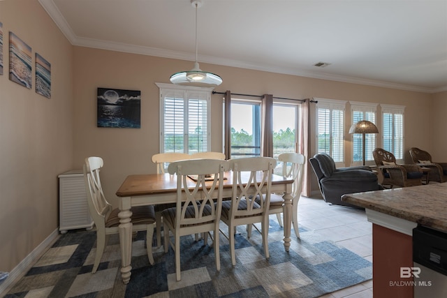 dining room featuring light tile patterned flooring, visible vents, baseboards, and ornamental molding